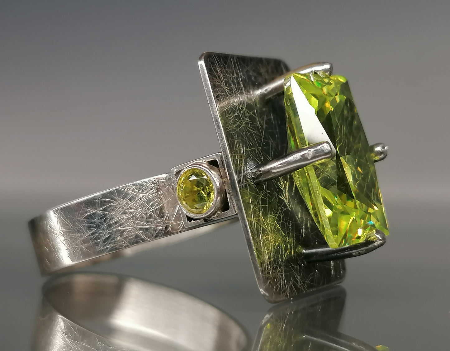 Moderner Ring mit einem grünen Stein