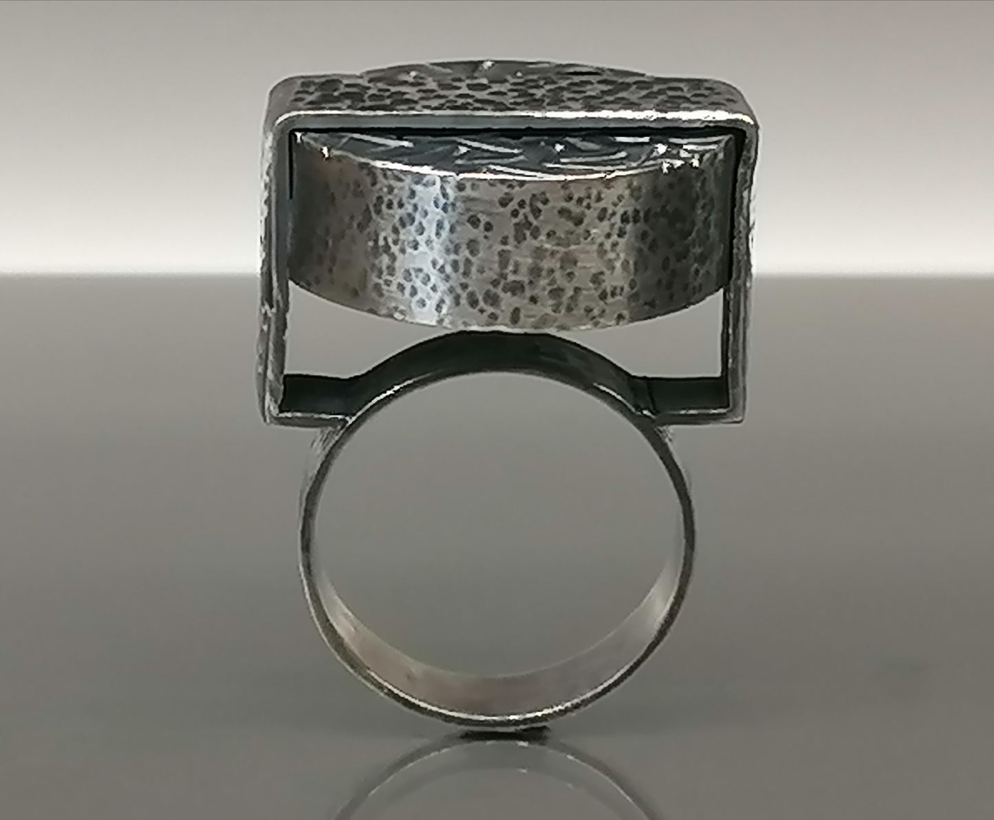 Large silver ring with a synthetic emerald