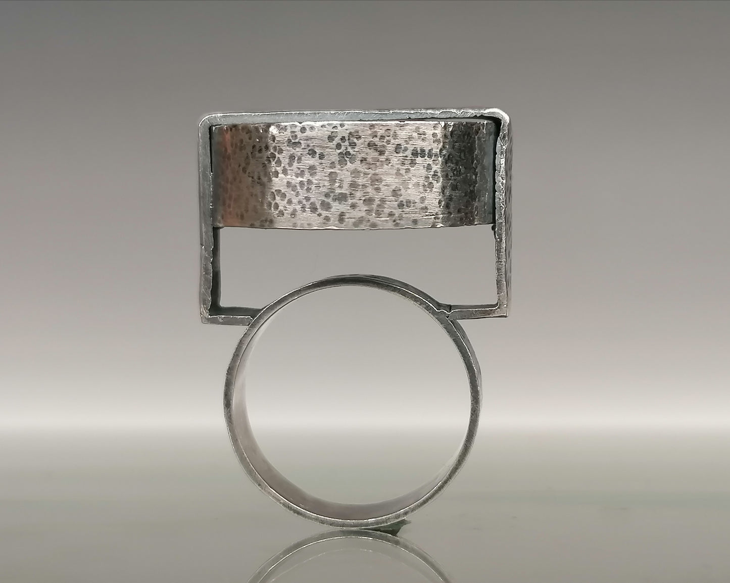 Large silver ring with a synthetic emerald