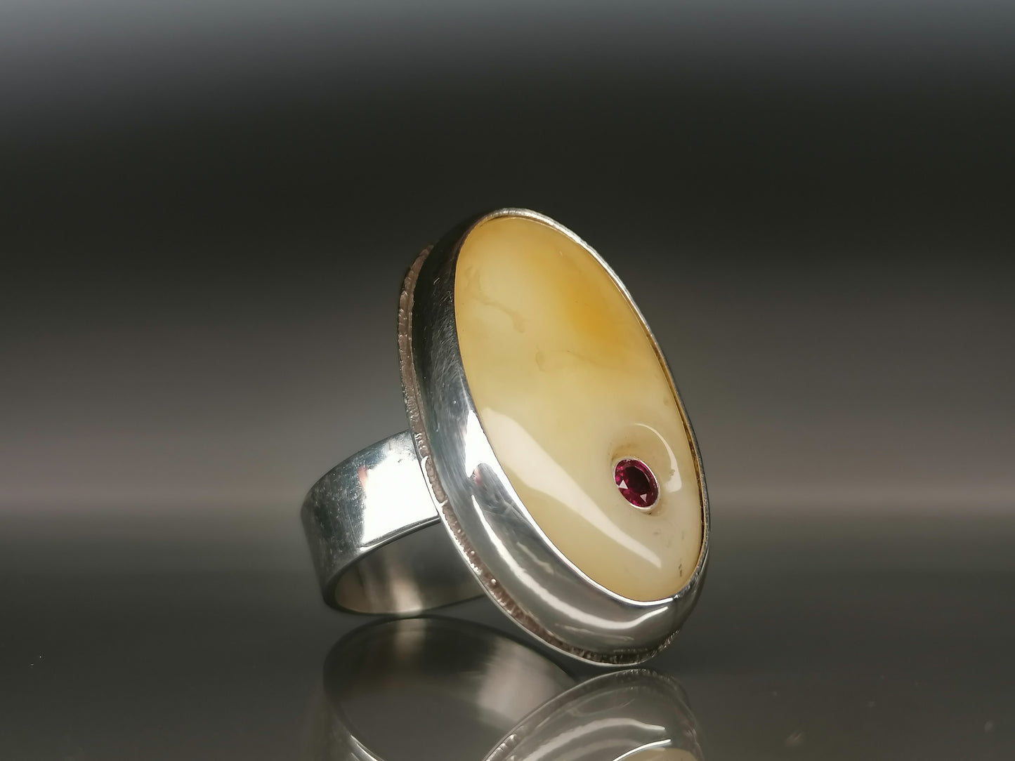 Large ring with milky amber and zircon