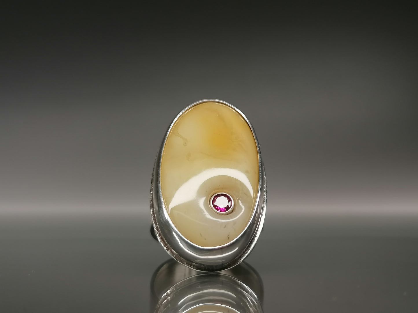 Large ring with milky amber and zircon