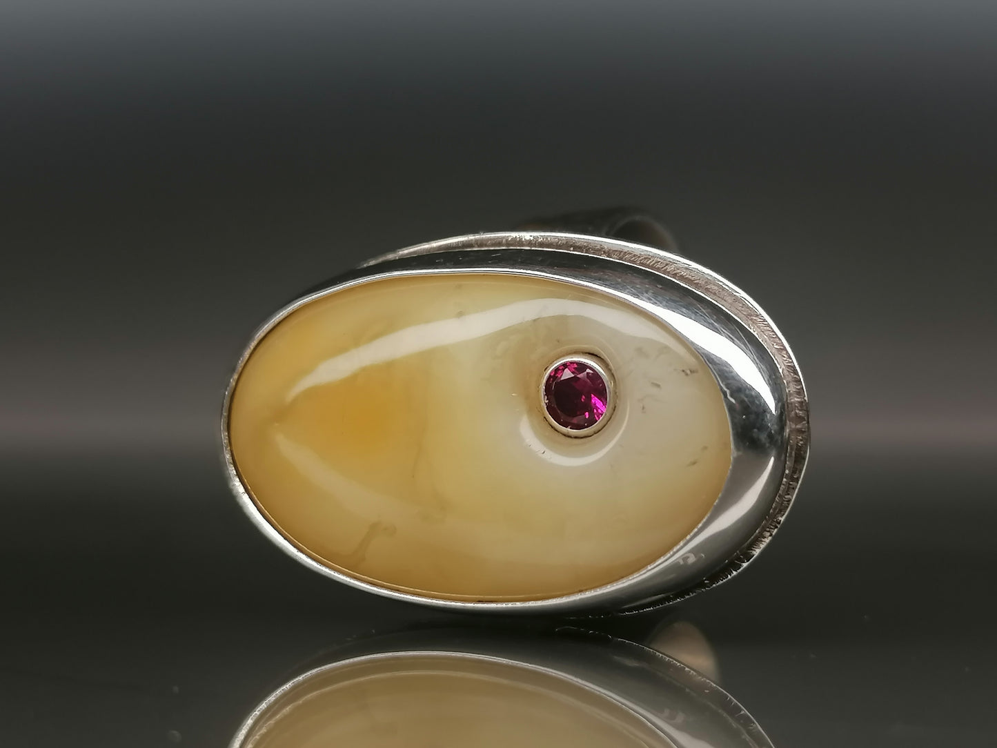 Large ring with milky amber and zircon