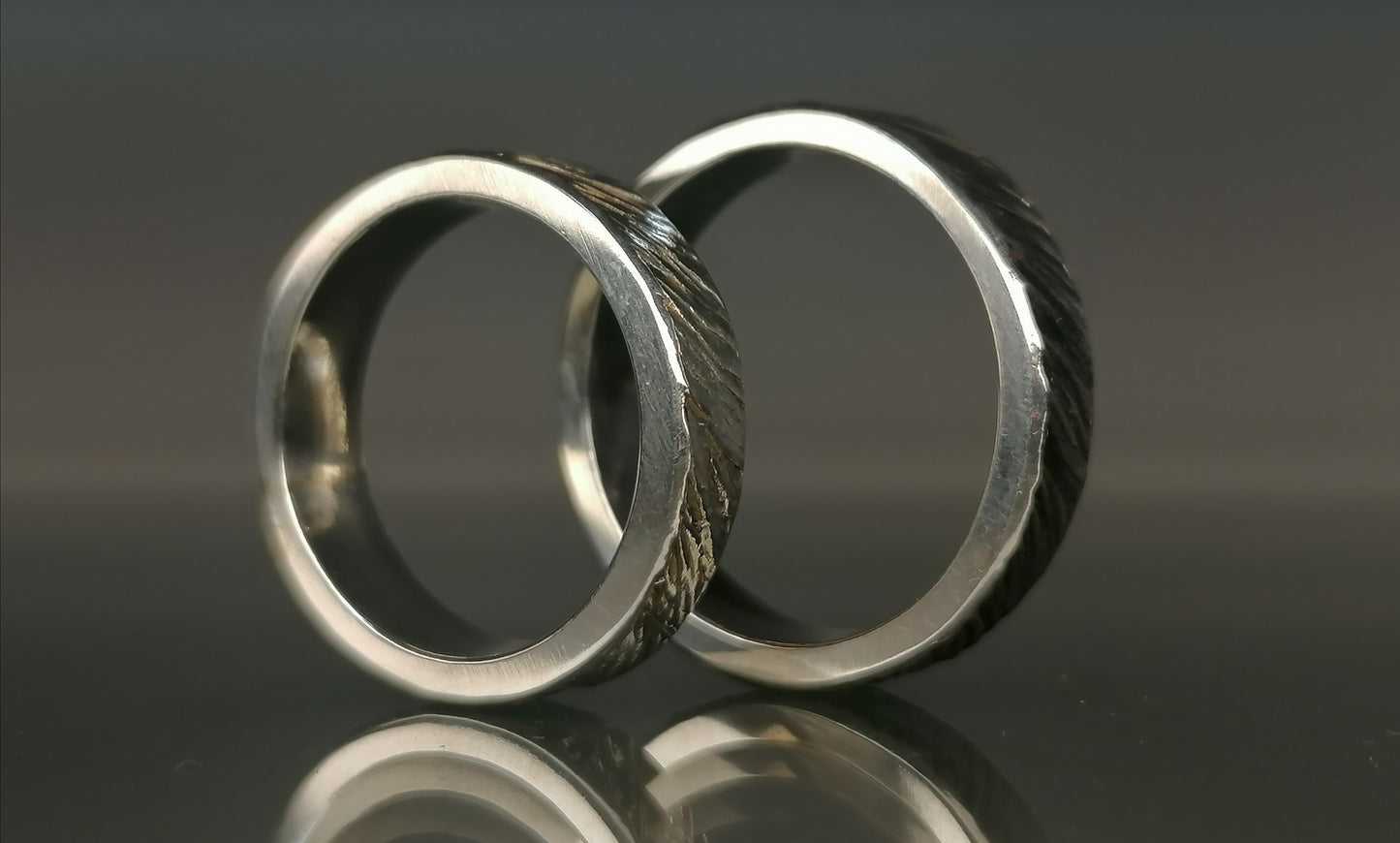 A set of silver craft wedding rings 