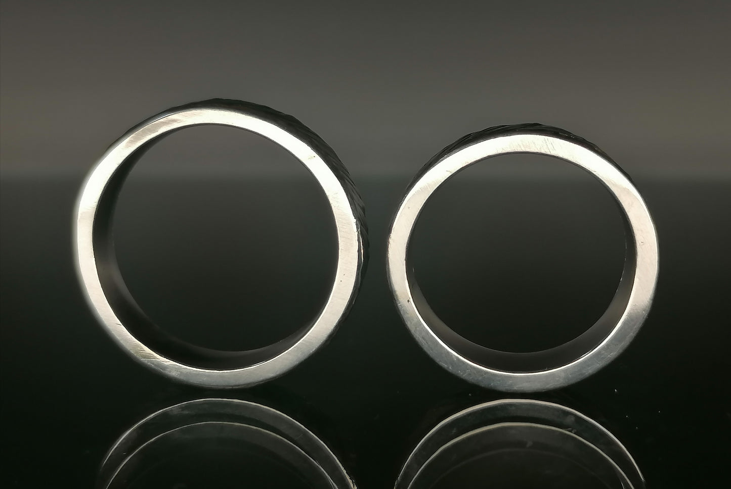 A set of silver craft wedding rings 