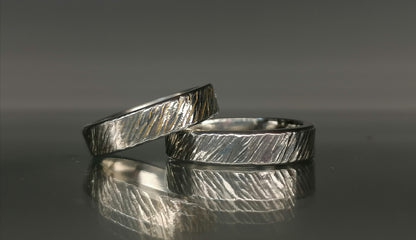 A set of silver craft wedding rings 