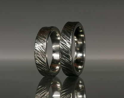 A set of silver craft wedding rings 