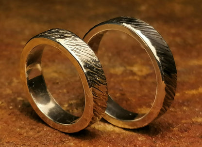 A set of silver craft wedding rings 