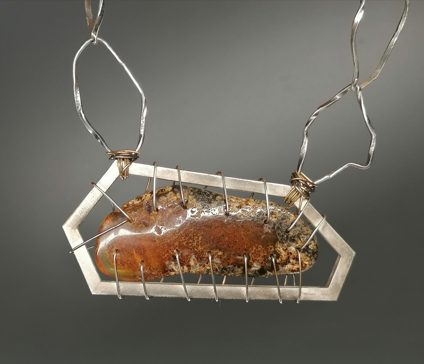 A unique silver necklace with amber 